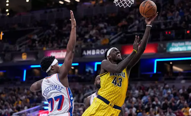 Indiana Pacers forward Pascal Siakam (43) shoots in front of Philadelphia 76ers guard Vj Edgecombe (77) during the first half of an NBA basketball game in Indianapolis, Wednesday, Oct. 28, 2026. (AP Photo/Michael Conroy)