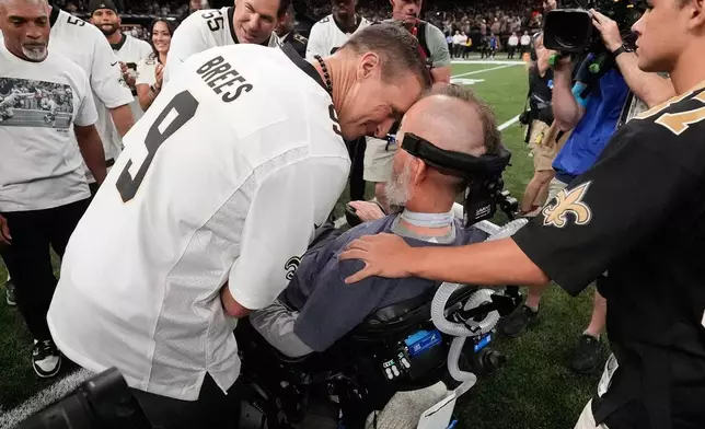 Former New Orleans Saints quarterback Drew Brees, foreground left, talks with former teammate Steve Gleason before an NFL football game against the Atlanta Falcons in New Orleans, Monday, Oct. 5, 2026. (AP Photo/Gerald Herbert)