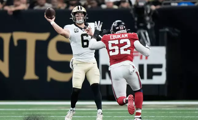 New Orleans Saints quarterback Tyler Shough (6) passes as Atlanta Falcons defensive end Samson Ebukam (52) applies pressure during the first half of an NFL football game in New Orleans, Monday, Oct. 5, 2026. (AP Photo/Gerald Herbert)