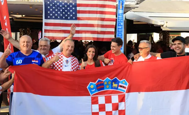 Ashton and Zachary Smith pose with Croatian supporters prior to the Nations League soccer match between Croatia and Spain, in Split, Croatia, Tuesday, Oct. 6, 2026. (AP Photo)