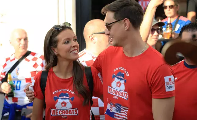 Ashton and Zachary Smith pose with Croatian supporters prior to the Nations League soccer match between Croatia and Spain, in Split, Croatia, Tuesday, Oct. 6, 2026. (AP Photo)