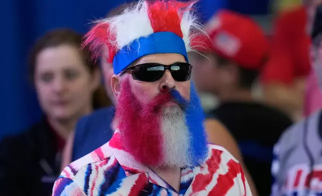 People arrive before President Donald Trump at a campaign rally at the Sioux Gateway Airport, Thursday, Oct. 22, 2026, in Sioux City, Iowa. (AP Photo/Charlie Neibergall)