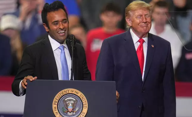 President Donald Trump listens a gubernatorial candidate Vivek Ramaswamy speaks at a campaign rally at the Covelli Centre, in Youngstown, Ohio, Monday, Oct. 12, 2026. (AP Photo/Gene J. Puskar)