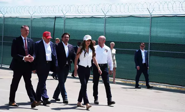 FILE - President Donald Trump, Gov. Ron DeSantis, R-Fla., and Homeland Security Secretary Kristi Noem and others tour "Alligator Alcatraz," a new migrant detention facility at Dade-Collier Training and Transition facility, July 1, 2025, in Ochopee, Fla. (AP Photo/Evan Vucci, File)