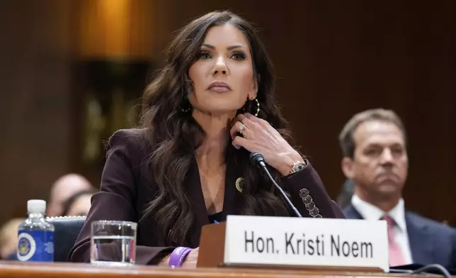 FILE - Homeland Security Secretary Kristi Noem, center, with her husband Bryon Noem, right, seated behind her, appears for an oversight hearing before the Senate Judiciary Committee, at the Capitol in Washington, March 3, 2026. (AP Photo/J. Scott Applewhite, File)