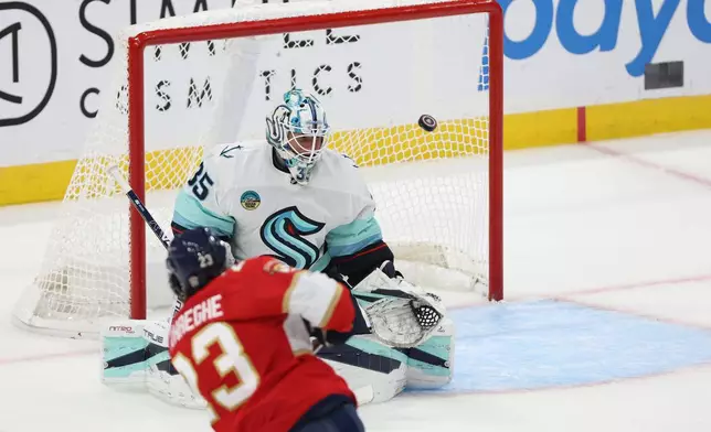 Florida Panthers center Carter Verhaeghe (23) scores a goal past Seattle Kraken goaltender Joey Daccord (35) during the first period of an NHL hockey game, Saturday, Oct. 17, 2026, in Sunrise, Fla. (AP Photo/David Santiago)