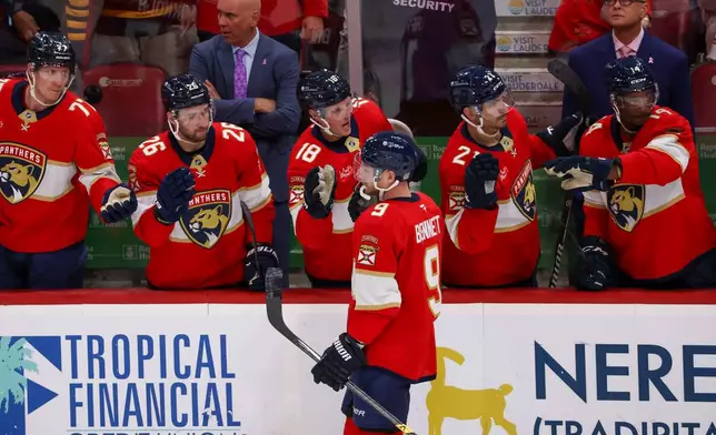 Florida Panthers center Sam Bennett (9) celebrates with teammates after scoring his second goal of an NHL hockey game during the second period against the Seattle Kraken, Saturday, Oct. 17, 2026, in Sunrise, Fla. (AP Photo/David Santiago)