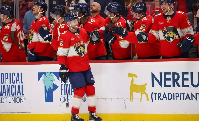 Florida Panthers center Sam Bennett (9) celebrates with teammates after scoring during the first period of an NHL hockey game against the Seattle Kraken, Saturday, Oct. 17, 2026, in Sunrise, Fla. (AP Photo/David Santiago)