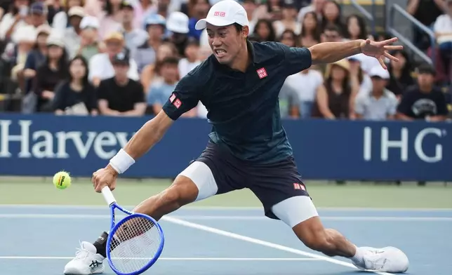 FILE - Kei Nishikori, of Japan, reaches to return the ball to Michael Antonius, of the United States, during a qualifying match at the U.S. Open tennis championships on Aug. 26, 2026, in New York. (AP Photo/Frank Franklin II, File)