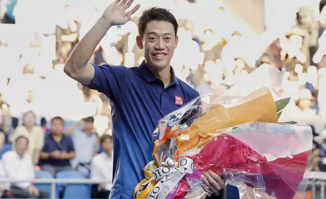 Japan's Kei Nishikori waves as he leaves the court following his first round loss to Frances Tiafoe of the U.S., at the Japan Open tennis championship in Tokyo, Thursday, Oct. 1, 2026. (Daiki Katagiri/Kyodo News via AP)