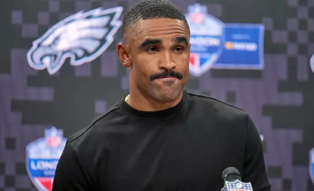Philadelphia Eagles quarterback Jalen Hurts (1) attends a press conference after an NFL football game against Jacksonville Jaguars in London, Sunday, Oct. 11, 2026. (AP Photo/Alastair Grant)