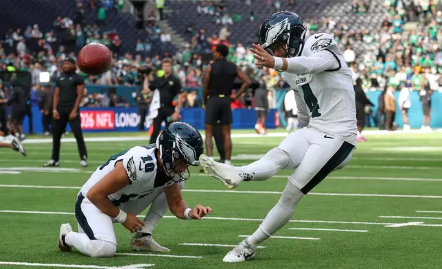 Philadelphia Eagles place kicker Jake Elliott (4) kicks the ball as he warms-up before an NFL football game against Jacksonville Jaguars in London, Sunday, Oct. 11, 2026. (AP Photo/Ian Walton)