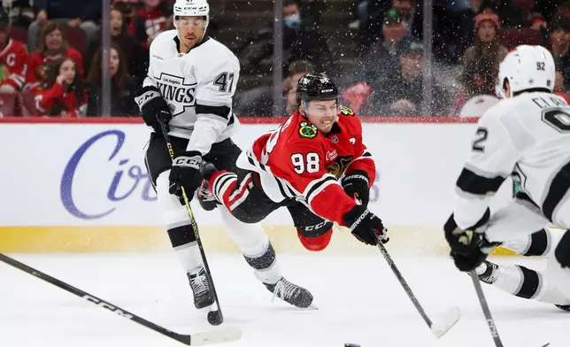Chicago Blackhawks center Connor Bedard (98) attempts to shoot against Los Angeles Kings left wing Andre Lee (47) during the second period of an NHL hockey game, Tuesday, Oct. 27, 2026, in Chicago. (AP Photo/Jessie Alcheh)