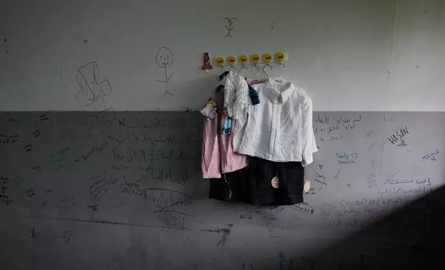 Clothes hang on a wall at a school being used as a shelter for people whose villages in southern Lebanon were destroyed or occupied by Israeli forces, in the southern port city of Tyre, Lebanon, Friday, Oct. 2, 2026. (AP Photo/Bilal Hussein)