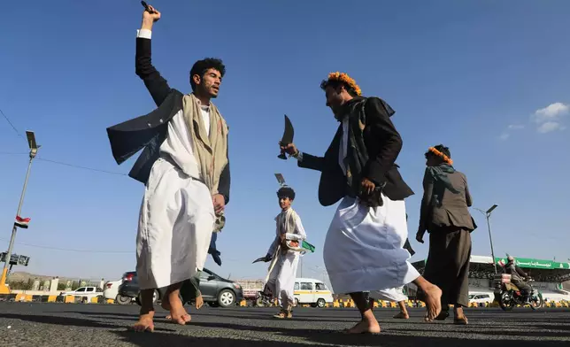 Men dance during a wedding celebration in a street in Sanaa, Yemen, Thursday, Oct. 8, 2026. (AP Photo/Osamah Abdulrahman)