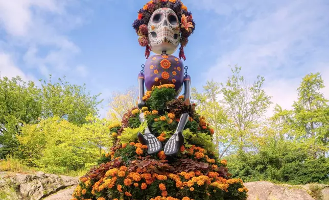 This image provided by the New York Botanical Garden shows a traditional marigold-adorned La Catrina sculpture on display during the site's Dia de los Muertos celebration in the Bronx borough of New York on Sept. 29, 2026. (New York Botanical Garden via AP)