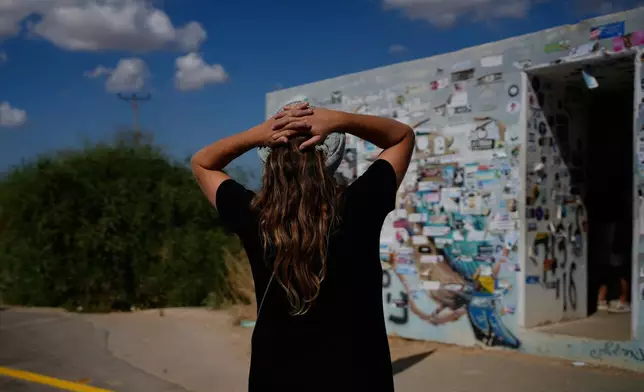 People visit a roadside bomb shelter where people were killed during the deadly Oct. 7, 2023, Hamas attack along the Israel-Gaza border, as the country marks the third anniversary of the attack, near Kibbutz Reim, southern Israel, Wednesday, Oct. 7, 2026. (AP Photo/Ohad Zwigenberg)