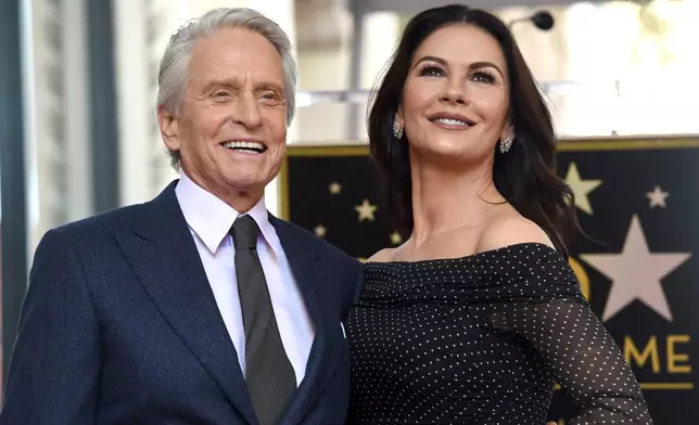 FILE - Actor Michael Douglas, left, and his wife Catherine Zeta-Jones appear at a ceremony honoring him with a star on the Hollywood Walk of Fame in Los Angeles on Nov. 6, 2018. (Photo by Chris Pizzello/Invision/AP, File)