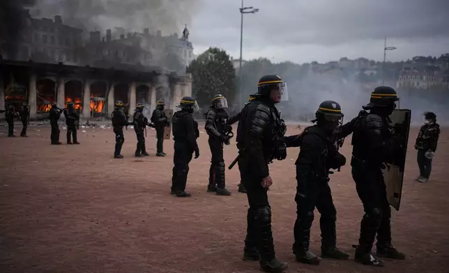 Riot police face protesters during a demonstration against rising living costs and in support of students' grievances in Paris, Saturday, Oct. 17, 2026. (AP Photo/Laurent Cipriani)