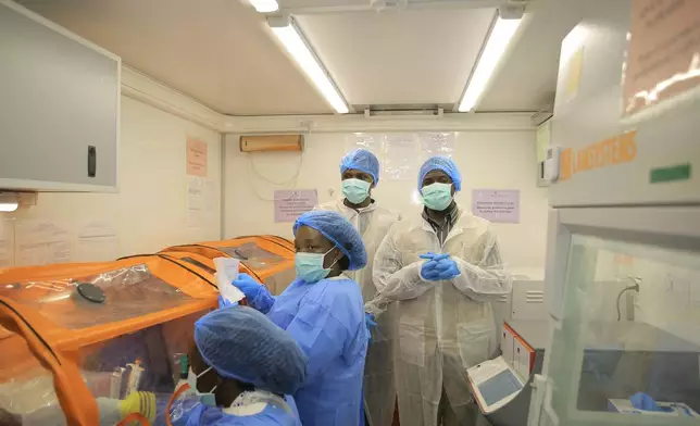 Medical workers work inside a mobile lab set up to test rapidly for Ebola virus in Butembo, Congo, Wednesday, Sept. 30, 2026. (AP Photo/Sebastien Kitsa Musayi)