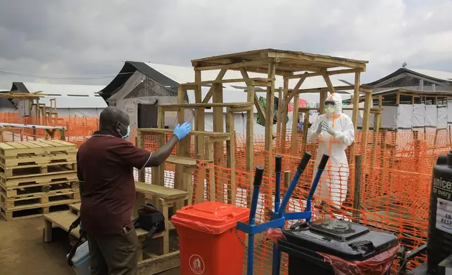 Health workers talk inside a Ebola treatment camp in Butembo, Congo, Wednesday, Sept. 30, 2026. (AP Photo/Sebastien Kitsa Musayi)