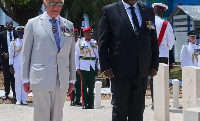Britain's King Charles III, left, and Guyana's Prime Minister Mark Anthony Phillip attend a wreath-laying ceremony at the Commonwealth War Graves in Georgetown, Guyana, Friday, Oct. 30, 2026. (AP Photo/Delano Williams)