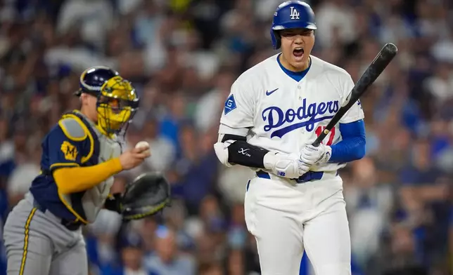 Los Angeles Dodgers designated hitter Shohei Ohtani reacts to being walked during the sixth inning of Game 3 of baseball's National League Championship Series between the Milwaukee Brewers and the Los Angeles Dodgers, Wednesday, Oct. 14, 2026, in Los Angeles. (AP Photo/Gregory Bull)