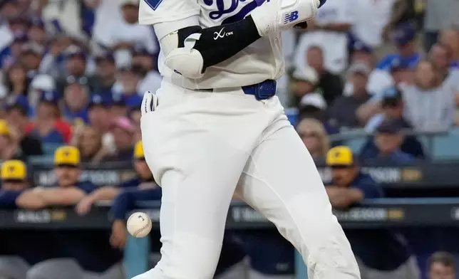 Los Angeles Dodgers designated hitter Shohei Ohtani is hit by a pitch during the fourth inning of Game 3 of baseball's National League Championship Series between the Milwaukee Brewers and the Los Angeles Dodgers, Wednesday, Oct. 14, 2026, in Los Angeles. (AP Photo/Ashley Landis)
