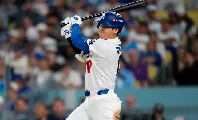 Los Angeles Dodgers designated hitter Shohei Ohtani follows through on a base hit during the eighth inning of Game 3 of baseball's National League Championship Series between the Milwaukee Brewers and the Los Angeles Dodgers, Wednesday, Oct. 14, 2026, in Los Angeles. (AP Photo/Ashley Landis)