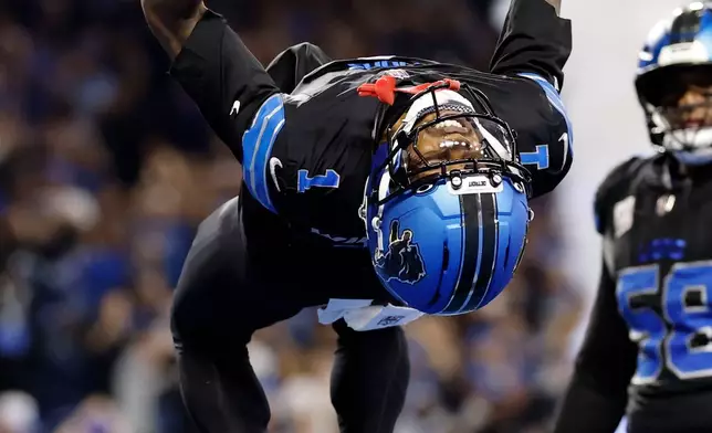 Detroit Lions wide receiver Jameson Williams (1) does a flip after catching a touchdown pass during the second half of an NFL football game against the Green Bay Packers, Sunday, Oct. 25, 2026, in Detroit. (AP Photo/Rey Del Rio)