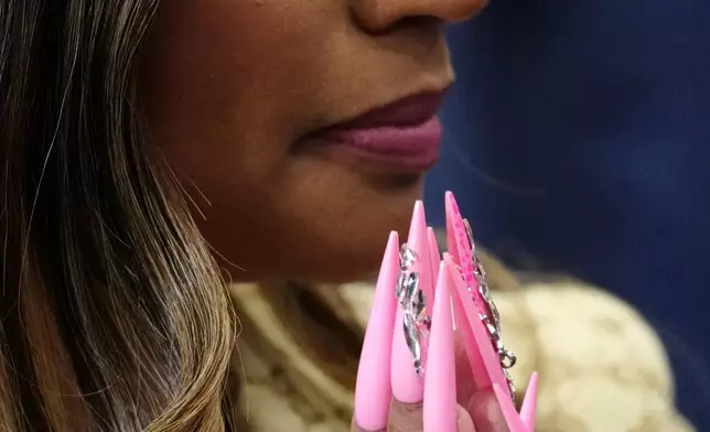 Nicki Minaj listens as President Donald Trump speaks during a campaign rally at McMorran Place Sports and Entertainment Center, Sunday, Oct. 25, 2026, in Port Huron, Mich. (AP Photo/Julia Demaree Nikhinson)