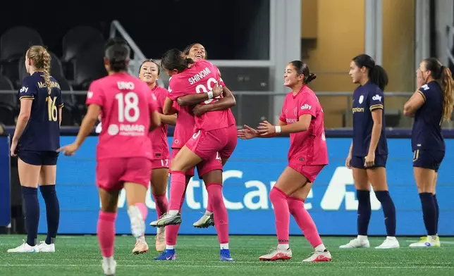 North Carolina Courage forward Gianna Paul, center facing, celebrates her goal with teammate Shinomi Koyama (20) during the second half of an NWSL soccer match against the Seattle Reign FC, Friday, Oct. 2, 2026, in Seattle. (AP Photo/Lindsey Wasson)