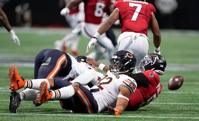 Chicago Bears defensive end Daniel Hardy (92) sacks Atlanta Falcons quarterback Michael Penix Jr. (9) and causes a fumble that was recovered by the Falcons during the first half of an NFL football game in Atlanta, Sunday, Oct. 18, 2026. (AP Photo/Brynn Anderson)