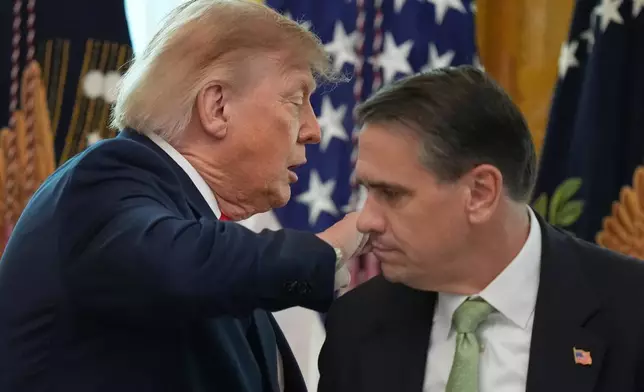 President Donald Trump walks past Attorney General Todd Blanche after speaking at a roundtable event in the East Room of the White House, Wednesday, Oct. 21, 2026, in Washington. (AP Photo/Alex Brandon)
