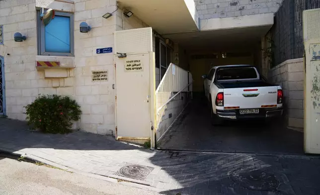 A car enters the British Consulate after the sign outside the consulate was taken down, in east Jerusalem, Thursday, Oct. 8, 2026. (AP Photo/Mahmoud Illean)
