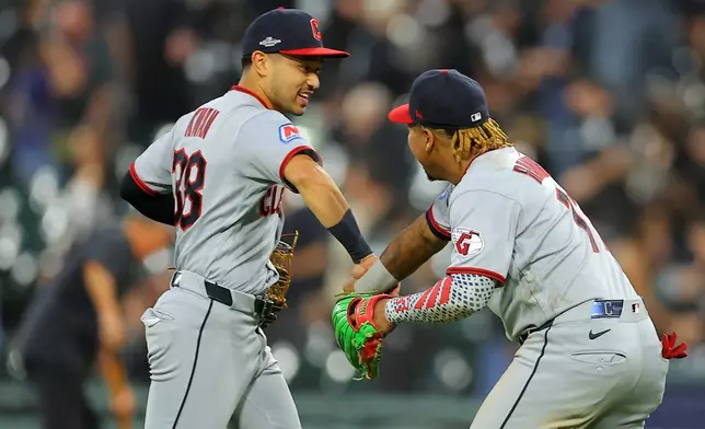 Cleveland Guardians' Steven Kwan, left, and José Ramírez celebrate after winning Game 3 of baseball's American League Division Series against the Chicago White Sox Wednesday, Oct. 7, 2026, in Chicago. (AP Photo/Melissa Tamez)