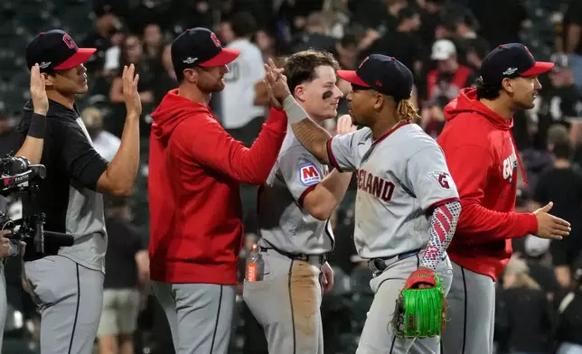 Cleveland Guardians' José Ramírez, second from right, celebrates with teammates after the Guardians won Game 3 of baseball's American League Division Series against the Chicago White Sox Wednesday, Oct. 7, 2026, in Chicago. (AP Photo/Nam Y. Huh)