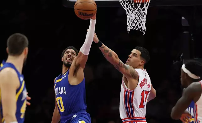 Indiana Pacers' Tyrese Haliburton (0) and Brooklyn Nets' Michael Porter Jr. (17), second from right, compete for a rebound during the first half of an NBA basketball game Sunday, Oct. 25, 2026, in New York. (AP Photo/Pamela Smith)