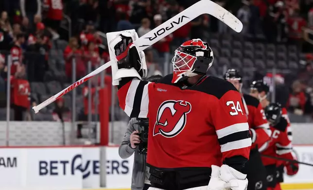 New Jersey Devils goaltender Jake Allen reacts after defeating the Vancouver Canucks in an NHL hockey game Saturday, Oct. 10, 2026, in Newark, N.J. (AP Photo/Adam Hunger)