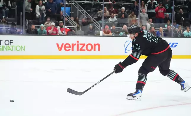 Seattle Kraken center Bobby McMann makes the game-winning goal during a shootout against the Detroit Red Wings in an NHL hockey game Tuesday, Oct. 20, 2026, in Seattle. (AP Photo/Lindsey Wasson)