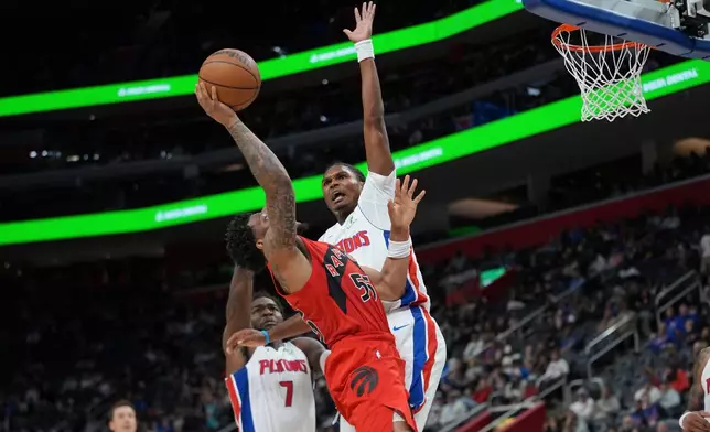 Detroit Pistons' Ausar Thompson (9) defends Toronto Raptors guard Alijah Martin (55) in the second half of a preseason NBA basketball game in Detroit, Friday, Oct. 16, 2026. (AP Photo/Paul Sancya)