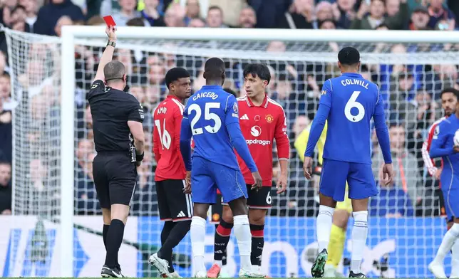 Referee Peter Bankes shows a red card to Manchester United's Lisandro Martinez (6) during the English Premier League soccer match between Chelsea and Manchester United in London, Saturday, Oct. 31, 2026. (AP Photo/Ian Walton)