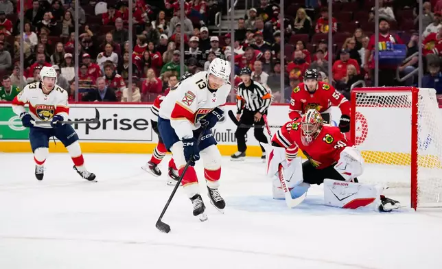 Florida Panthers center Sam Reinhart (13) controls the puck during the first period of an NHL hockey game against the Chicago Blackhawks, Sunday, Oct. 25, 2026, in Chicago. (AP Photo/Harry Figiel)