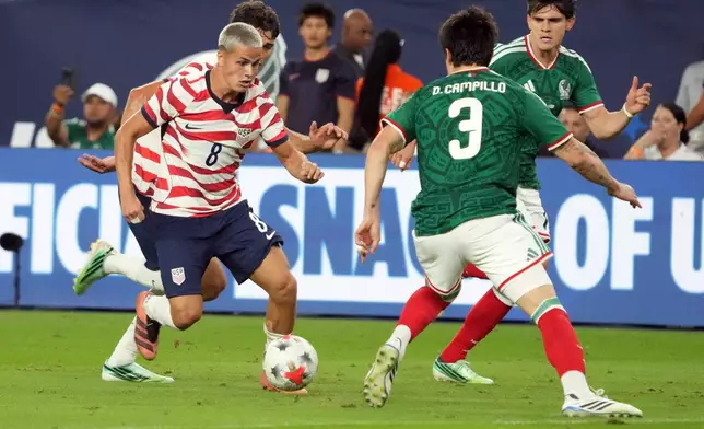 U.S. forawrd Cavan Sullivan (8) drives on Mexico defenseman Diego Vasquez in the second half of an international friendly soccer match in Glendale, Ariz., Saturday, Oct. 3, 2026. (AP Photo/Rick Scuteri)