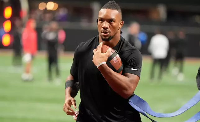 Atlanta Falcons running back Bijan Robinson warms up before an NFL football game against the Baltimore Ravens, Sunday, Oct. 11, 2026, in Atlanta. (AP Photo/Mike Stewart)