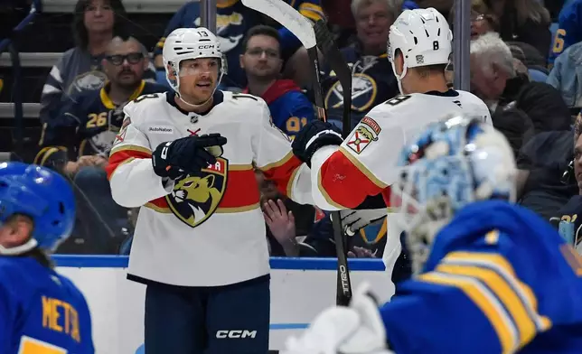 Florida Panthers center Sam Reinhart, left, celebrates with left wing Brady Tkachuk after scoring during the second period of an NHL hockey game against the Buffalo Sabres, Monday, Oct. 12, 2026, in Buffalo, N.Y. (AP Photo/Adrian Kraus)