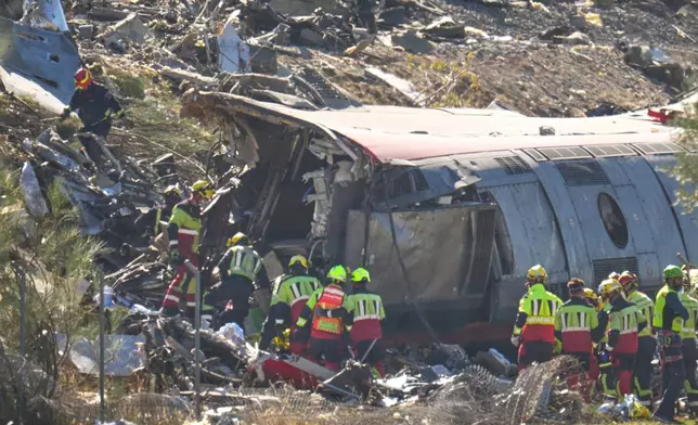 Emergency services work at the scene of a collision between two trains in Urda, Spain, Wednesday, Oct. 28, 2026. (AP Photo/Manu Fernandez)
