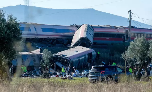 Emergency services attend to the victims at the scene of a collision between two trains in Urda, Spain, on Wednesday, Oct. 28, 2026. (Juanma Jiménez/Europa Press via AP)