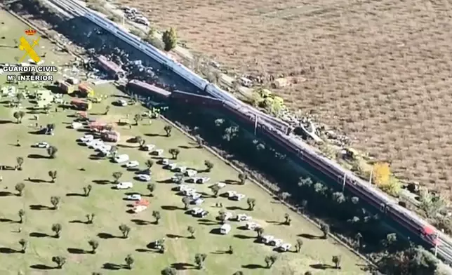 This framegrab taken from a video provided by Guardia Civil shows an aerial view of carriages and first responders on the site of a collision between two trains in Urda, Spain, Wednesday Oct. 28, 2026. (Guardia Civil via AP)