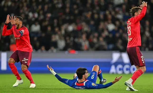 PSG's Ferran Torres, bottom, reacts during the French League One soccer match between Paris Saint-Germain and Lyon in Paris, Monday, Oct. 26, 2026. (AP Photo/Emma Da Silva)